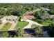 Beautiful aerial view of a well-maintained home with lush landscaping and a circular driveway at 257 Sweet Bay Dr, New Smyrna Beach, FL 32168