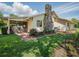 Exterior view with a charming stone chimney, screened in patio, and landscaped grounds, offering privacy and outdoor enjoyment at 257 Sweet Bay Dr, New Smyrna Beach, FL 32168