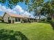 Lush backyard with manicured hedges and a covered patio, creating a private outdoor retreat at 257 Sweet Bay Dr, New Smyrna Beach, FL 32168