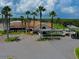 Aerial view of the clubhouse with ample parking, lush greenery, and palm tree accents at 257 Sweet Bay Dr, New Smyrna Beach, FL 32168