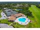 Aerial view of a community pool with lounge chairs, a clubhouse, and tennis courts at 257 Sweet Bay Dr, New Smyrna Beach, FL 32168