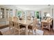 Bright dining area featuring hardwood floors, large windows, and a comfortable seating arrangement at 257 Sweet Bay Dr, New Smyrna Beach, FL 32168