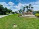 Sugar Mill Country Club entrance sign surrounded by manicured lawn and palm trees at 257 Sweet Bay Dr, New Smyrna Beach, FL 32168