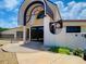 Club entrance featuring unique architectural design, glass block accents and well maintained landscaping at 257 Sweet Bay Dr, New Smyrna Beach, FL 32168