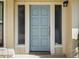 Stylish blue front door flanked by sidelights, welcoming you into a bright and modern home at 257 Sweet Bay Dr, New Smyrna Beach, FL 32168