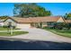 Charming single-story home with a well-manicured lawn and circular driveway, perfect for a welcoming curb appeal at 257 Sweet Bay Dr, New Smyrna Beach, FL 32168