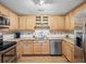 Well-lit kitchen featuring modern appliances, wooden cabinets, and hardwood flooring at 257 Sweet Bay Dr, New Smyrna Beach, FL 32168