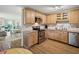 Kitchen with wooden cabinets, stainless steel appliances, and a view of the living room at 257 Sweet Bay Dr, New Smyrna Beach, FL 32168