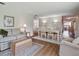Inviting living room and dining room area with hardwood floors, a cozy sofa, and a bright atmosphere at 257 Sweet Bay Dr, New Smyrna Beach, FL 32168
