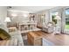 Cozy living room and dining room area with hardwood flooring, comfortable seating, and lots of natural light at 257 Sweet Bay Dr, New Smyrna Beach, FL 32168