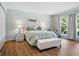 Serene main bedroom with wood floors, a window view, and soft, neutral tones at 257 Sweet Bay Dr, New Smyrna Beach, FL 32168