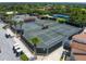Well maintained outdoor tennis courts with shaded areas and golf cart parking spots at 257 Sweet Bay Dr, New Smyrna Beach, FL 32168
