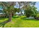 Expansive backyard with mature trees and lush green grass, offering a peaceful and private outdoor space at 2576 Sunset Dr, New Smyrna Beach, FL 32168