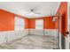Bright bedroom with vibrant orange walls, crown molding, and tile flooring at 2576 Sunset Dr, New Smyrna Beach, FL 32168