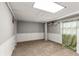Spacious bonus room with neutral carpet and white wainscoting ready to be personalized at 2576 Sunset Dr, New Smyrna Beach, FL 32168