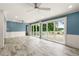 Open-concept living room with sliding glass doors leading to the outdoor patio and waterfront views at 2576 Sunset Dr, New Smyrna Beach, FL 32168