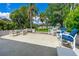 Expansive outdoor patio with dining set and seating overlooking lush landscaping and waterfront view at 2576 Sunset Dr, New Smyrna Beach, FL 32168