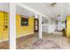Bright sun room with yellow walls, tile flooring, and an decorative window with wood trim at 2576 Sunset Dr, New Smyrna Beach, FL 32168