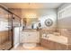 Elegant main bathroom features a walk-in shower, soaking tub, and granite countertops at 260 Portofino Blvd, New Smyrna Beach, FL 32168