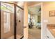 Modern bathroom with a glass-enclosed shower and a view into the bedroom at 260 Portofino Blvd, New Smyrna Beach, FL 32168