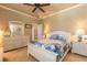 Comfortable bedroom featuring a dresser and nautical decor with neutral walls, ceiling fan and carpeted floor at 260 Portofino Blvd, New Smyrna Beach, FL 32168