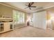 Spacious bedroom with plantation shutters, neutral walls, carpet, and built-in storage cabinet at 260 Portofino Blvd, New Smyrna Beach, FL 32168