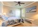 Cozy bedroom with neutral walls, carpeted floor, ceiling fan and a boat themed wall art at 260 Portofino Blvd, New Smyrna Beach, FL 32168