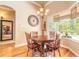 Cozy dining area with wood table, decorative lighting, and a view of the pool area through a large window at 260 Portofino Blvd, New Smyrna Beach, FL 32168