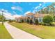 Beautiful single-story home boasting a barrel tile roof and lush, green lawn at 260 Portofino Blvd, New Smyrna Beach, FL 32168