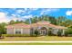 Charming one-story home with a well-manicured lawn, beautiful landscaping, and a tile roof at 260 Portofino Blvd, New Smyrna Beach, FL 32168