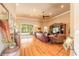 Bright living room with hardwood floors, a ceiling fan, and sliding glass doors leading to the outdoor area at 260 Portofino Blvd, New Smyrna Beach, FL 32168