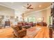 Spacious living room with hardwood floors, comfortable leather furniture, and a view to the kitchen at 260 Portofino Blvd, New Smyrna Beach, FL 32168