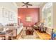 Cozy living room with hardwood floors and a large window offering natural light at 260 Portofino Blvd, New Smyrna Beach, FL 32168