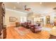 Hardwood floors and neutral paint are found throughout this spacious living room featuring comfortable leather furniture at 260 Portofino Blvd, New Smyrna Beach, FL 32168