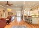 Open-concept living room with hardwood floors, tall ceilings, and seamless transition to the kitchen area at 260 Portofino Blvd, New Smyrna Beach, FL 32168