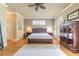 Comfortable main bedroom with hardwood floors, neutral paint, and ceiling fan at 260 Portofino Blvd, New Smyrna Beach, FL 32168