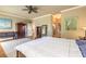 Inviting main bedroom offers hardwood floors, large bed, and views to the ensuite bathroom at 260 Portofino Blvd, New Smyrna Beach, FL 32168