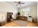 Bright office with a ceiling fan, neutral walls, and an outside view through plantation shutters at 260 Portofino Blvd, New Smyrna Beach, FL 32168