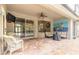 Covered patio featuring an outdoor lounging area, ceiling fan, and brick-paved flooring at 260 Portofino Blvd, New Smyrna Beach, FL 32168