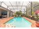 Beautiful screened pool area with a mural, lush landscaping, and comfortable seating at 260 Portofino Blvd, New Smyrna Beach, FL 32168