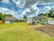 The spacious backyard includes a well-maintained lawn, shed, and outdoor seating at 2714 Yule Tree Dr, Edgewater, FL 32141