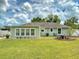 The spacious backyard includes a well-maintained lawn and an outdoor seating area at 2714 Yule Tree Dr, Edgewater, FL 32141