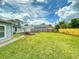 The spacious backyard includes a well-maintained lawn and an outdoor seating area at 2714 Yule Tree Dr, Edgewater, FL 32141