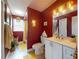 Well-lit bathroom with a modern vanity, contrasting walls, and a tub-shower combination for relaxation at 2714 Yule Tree Dr, Edgewater, FL 32141