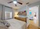 Inviting bedroom showcases a ceiling fan, light-filtering window shades, and tastefully curated wall decor at 2714 Yule Tree Dr, Edgewater, FL 32141