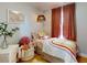 Cozy bedroom with playful decor, featuring a colorful bedspread and a charming hanging pendant light fixture at 2714 Yule Tree Dr, Edgewater, FL 32141