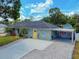 Charming single-story home features a well-manicured lawn and a bright yellow front door at 2714 Yule Tree Dr, Edgewater, FL 32141