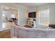 Comfortable living room with a sectional sofa, and a view of the kitchen. Perfect layout for modern living at 2714 Yule Tree Dr, Edgewater, FL 32141