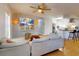 Inviting living room with modern decor, featuring a TV, comfortable seating, and an open view to the kitchen at 2714 Yule Tree Dr, Edgewater, FL 32141