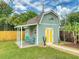 The backyard shed features a covered porch and is surrounded by lush landscaping at 2714 Yule Tree Dr, Edgewater, FL 32141